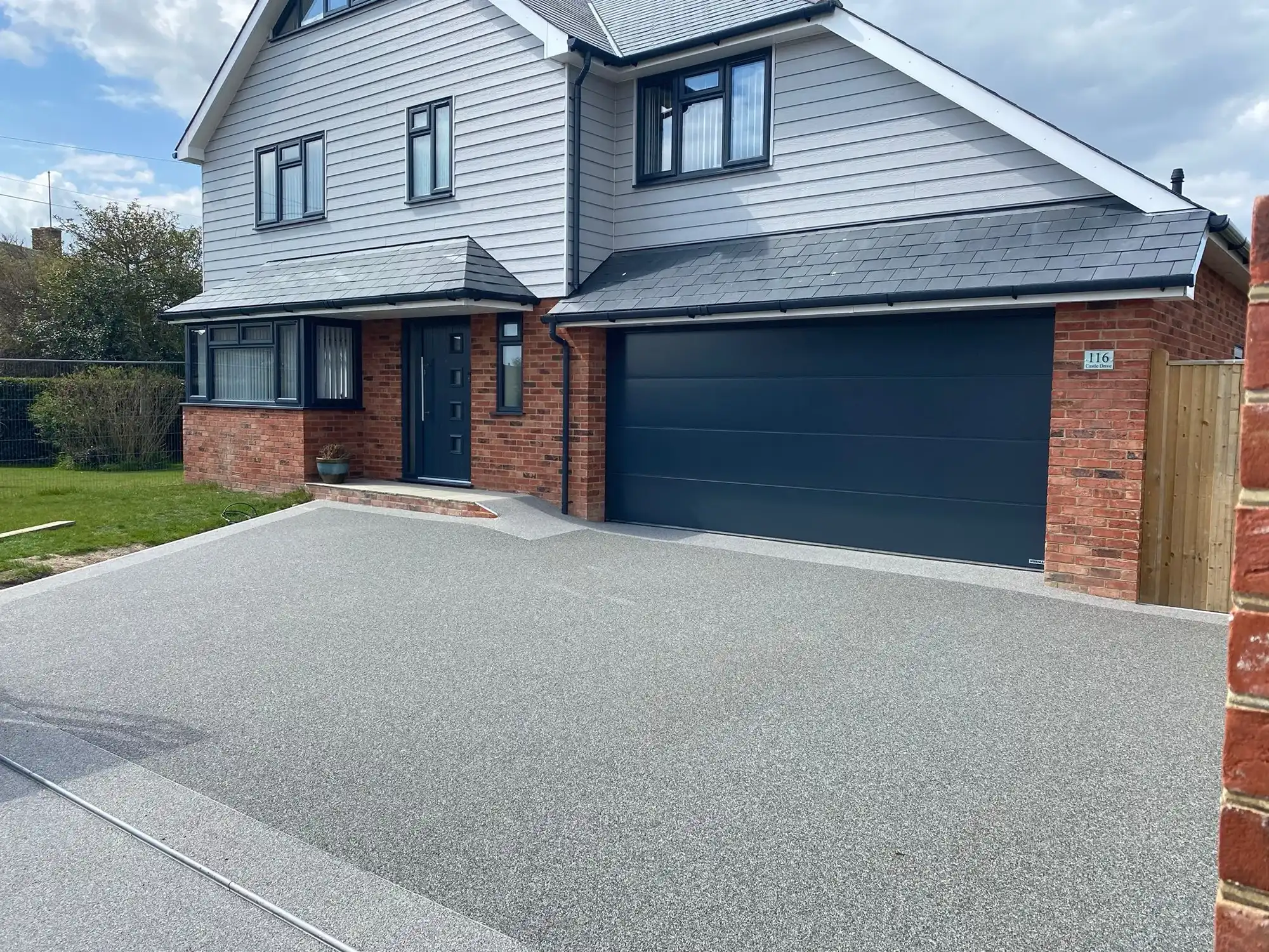 a two story house with a large driveway